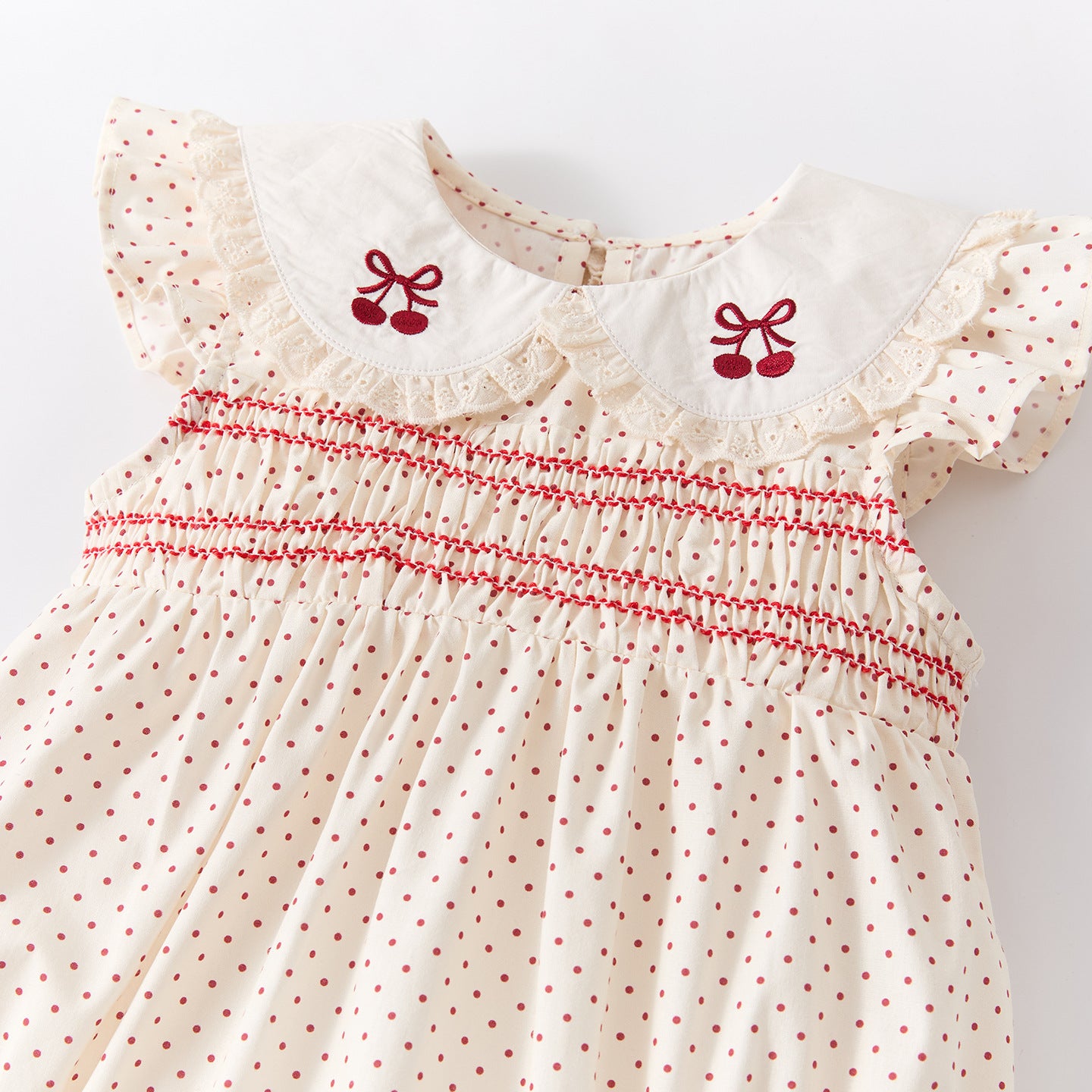 Polka dot romper with Peter Pan collar