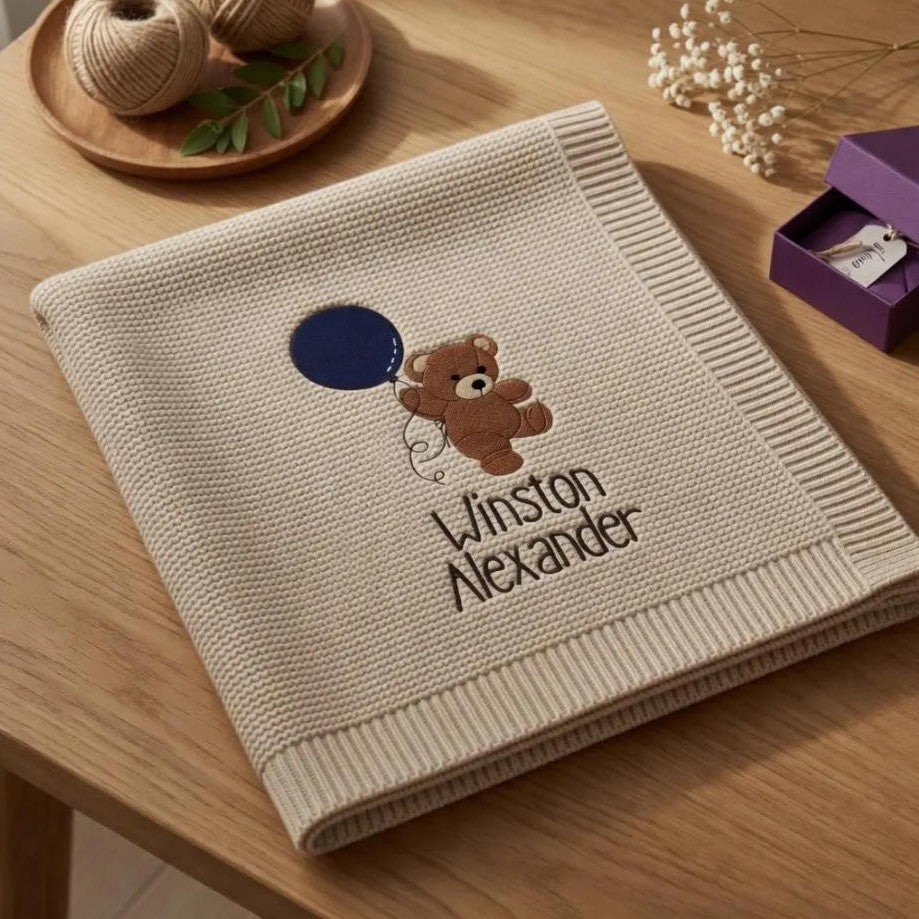 Knitted blanket with embroidered bear and name